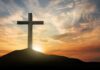 Cross on hill at sunset
