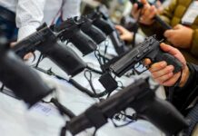 Handgun Reality Upends Rifle Panic Handguns on display at a store counter