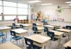 Empty classroom with rows of student desks and chairs