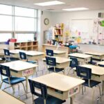 Empty classroom with rows of student desks and chairs