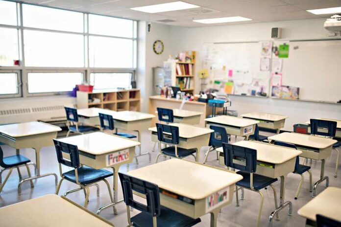 Empty classroom with rows of student desks and chairs