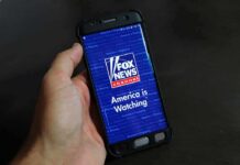 hand holding smartphone with Fox News app open