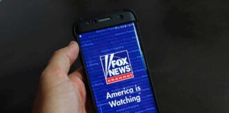 hand holding smartphone with Fox News app open