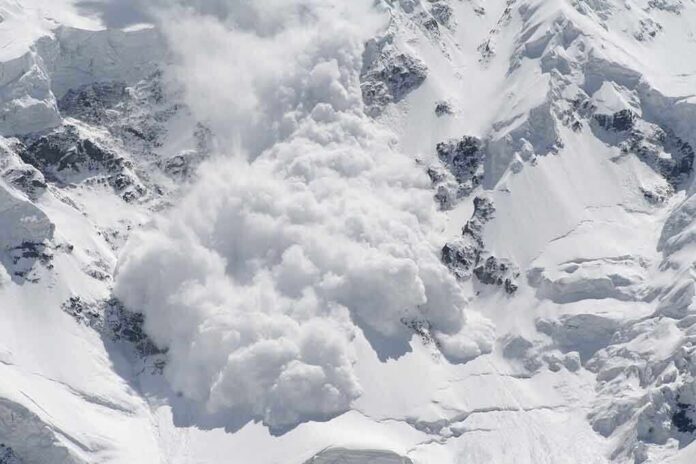 shutterstock_17964235 An avalanche occurring on a snowy mountain slope
