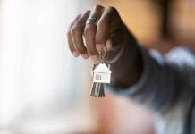 California Homeownership Now Starts At 47 Hand holding house-shaped keychain with keys