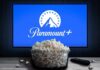Antitrust Standoff Triggers Paramount Escape Plan Glass bowl of popcorn in front of Paramount+ on TV