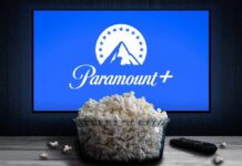 Antitrust Standoff Triggers Paramount Escape Plan Glass bowl of popcorn in front of Paramount+ on TV