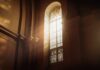 Rising Anti-Christian Attacks Exposed sunlit stained glass window in a church interior