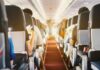 Free Upgrades DOWNSIZED on Key Routes Airplane cabin aisle with passengers seated