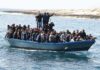 Crowded blue boat carrying many people on the sea