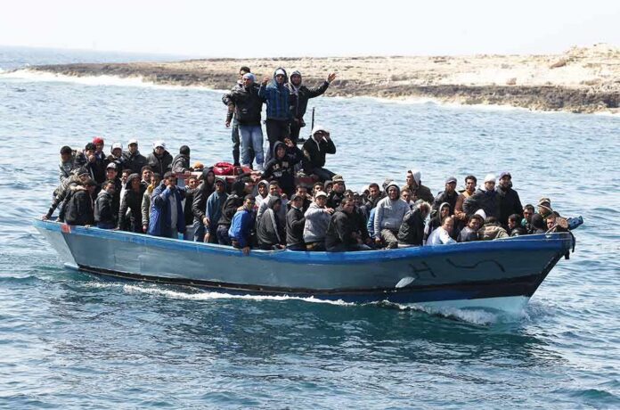shutterstock_697264741 Crowded blue boat carrying many people on the sea