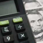 City’s Name-And-Shame List GUTTED – Mass Tax Notices TORCHED Calculator with tax buttons beside U.S. currency