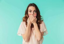 woman covering mouth with hands in surprise