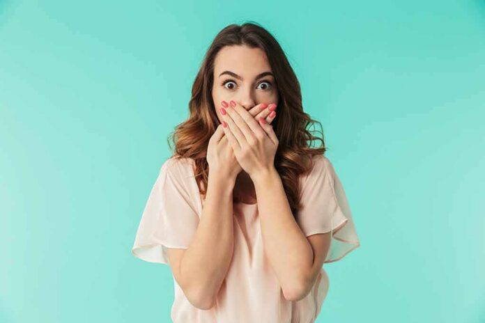 shutterstock_1060527773 woman covering mouth with hands in surprise