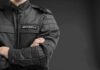 UnitedHealth Security Spree – Burr Slams ‘Presidential’ CEO Protection security guard in black uniform with crossed arms