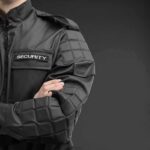 UnitedHealth Security Spree – Burr Slams ‘Presidential’ CEO Protection security guard in black uniform with crossed arms