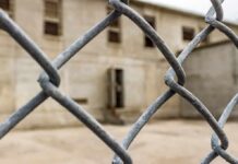 Chain-link fence with blurred concrete building behind
