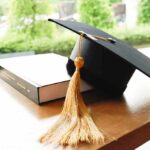 Flunked ROI? College Free Money Ends Here Graduation cap with gold tassel on a book
