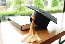 Flunked ROI? College Free Money Ends Here Graduation cap with gold tassel on a book
