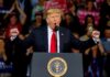 Power Move: Trump’s Ballroom Marches Forward Donald Trump speaking at a rally podium with arms raised