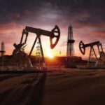 Oil Artery Hit – Cross-Border Drones Rattle Saudi Arabia Oil pumpjacks and derricks at sunset in a desert field