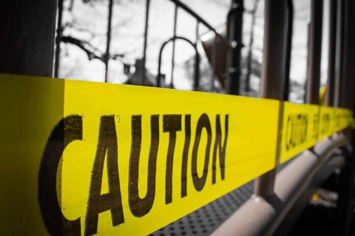 Yellow caution tape stretched across a metal playground structure