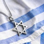 Hamas Plot Exposed: Berlin, Vienna on Edge Star of David pendant on blue and white cloth