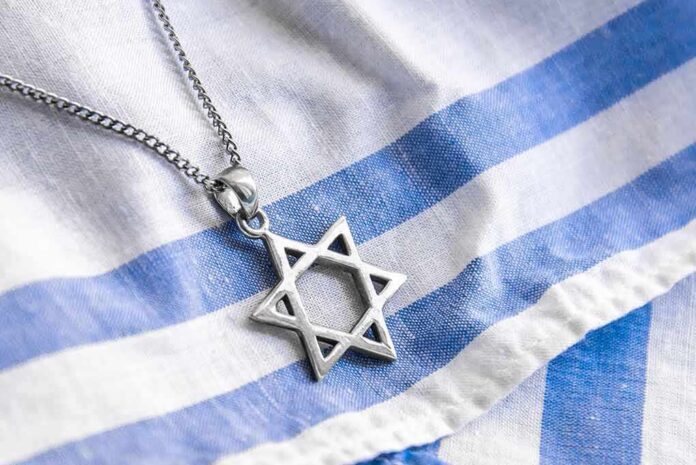 shutterstock_1813404718 Star of David pendant on blue and white cloth