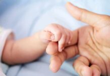 Texas Judge Slams Brakes On Newborn Tug-Of-War baby hand holding adult finger