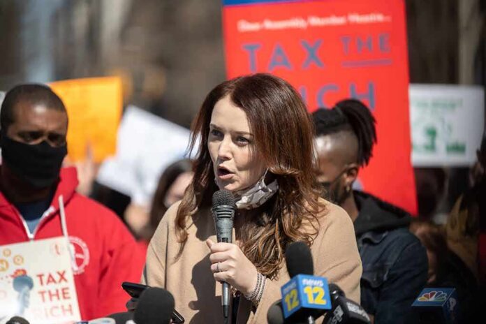 shutterstock_1940036284 Woman speaking into a microphone at a rally