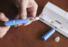 China Pipeline? Ozempic Scam Unmasked Hands assembling a blue insulin pen with packaging on a table
