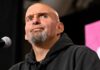 WSJ Bombshell Triggers Fetterman Meltdown bald man with goatee speaking at a microphone