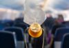 airplane oxygen mask hanging in cabin aisle