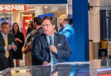 Receipts Or Retract: Hanson Corners Tucker Tucker Carlson at a news desk in a busy studio setting