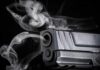 Unarmed Student—Why Did He Pull The Trigger? Close-up of a handgun muzzle with smoke swirling from the barrel