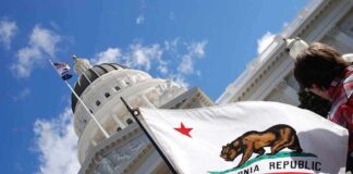 California state flag in front of a white domed capitol building