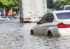 Bangkok DROWNS: Streets Turn To Rivers Silver car partially submerged in floodwater
