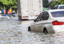 Bangkok DROWNS: Streets Turn To Rivers Silver car partially submerged in floodwater