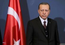 Child-Safety Sweep or Crackdown? Ankara Erupts Recep Tayyip Erdoğan standing beside a Turkish flag