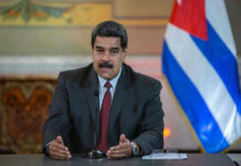 Election Heist? Machado Slips Past Blockade Nicolás Maduro speaking at a podium with a microphone
