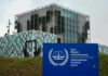 International Criminal Court building with sign in foreground.