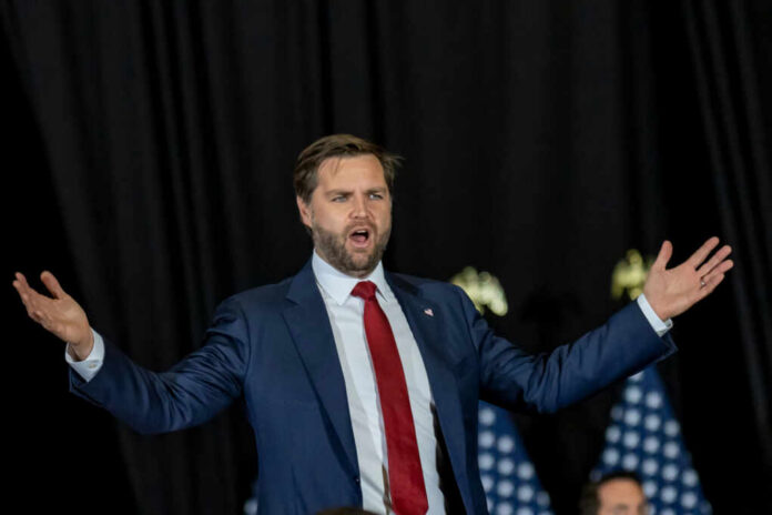 man in suit speaking with arms outstretched