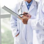 Voter Limits Defied? Doctors Sue Newsom Over Tax Hike Doctors reviewing a clipboard