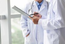 Voter Limits Defied? Doctors Sue Newsom Over Tax Hike Doctors reviewing a clipboard