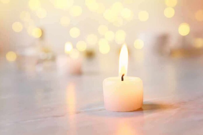 white tealight candle with soft flame