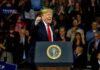 Donald Trump speaking at a rally behind a presidential podium