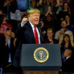 Win Congress, Get $5K – Or Get Burned? Donald Trump speaking at a rally behind a presidential podium