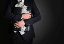 Bribery Trail? Senator Tied To Weed Empire Businessman hugging briefcase stuffed with cash