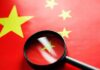 Magnifying glass over the Chinese flag