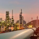 Refinery Hits Rattle Trump’s Fragile Truce Oil refinery with pipelines at sunset